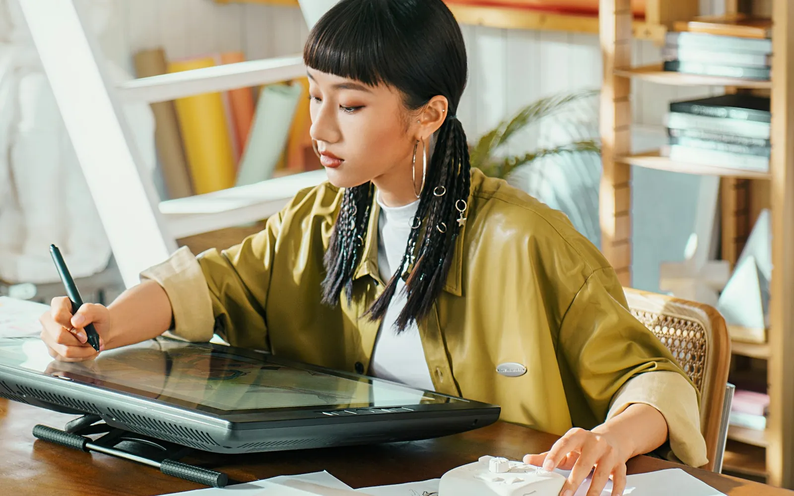 A designer creating vector artwork on a large pen display in her studio.
