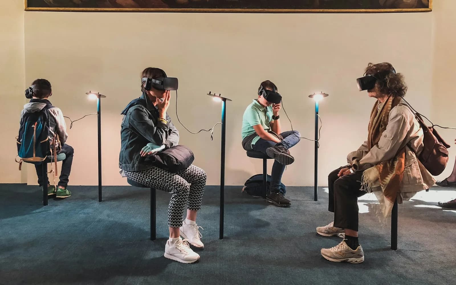 Four people exploring virtual reality experiences with headsets.