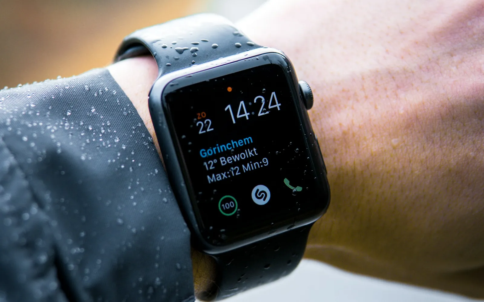 A smartwatch on a wrist showing health and weather data.
