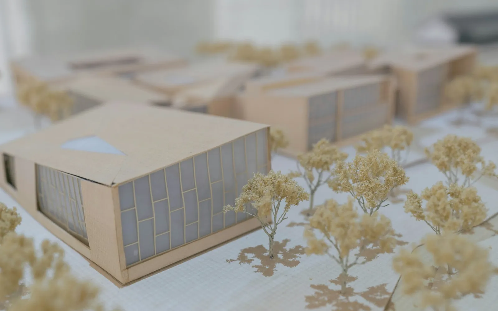 A detailed architectural massing model with landscaping.
