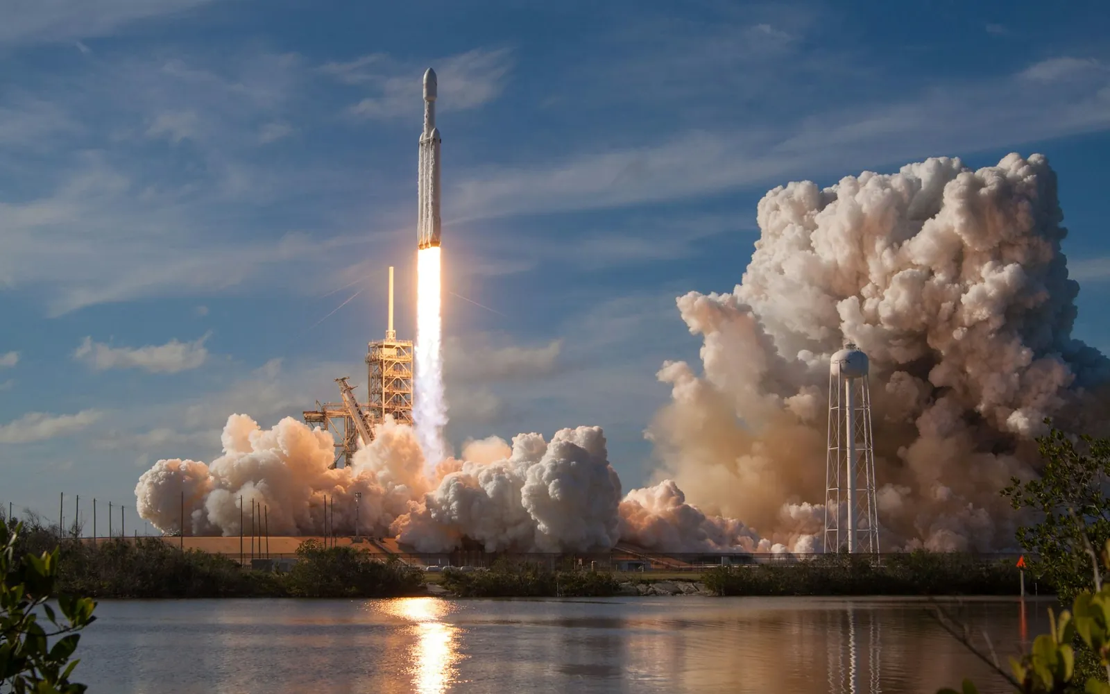 A rocket lifting off from the launch pad on a column of smoke and flame.
