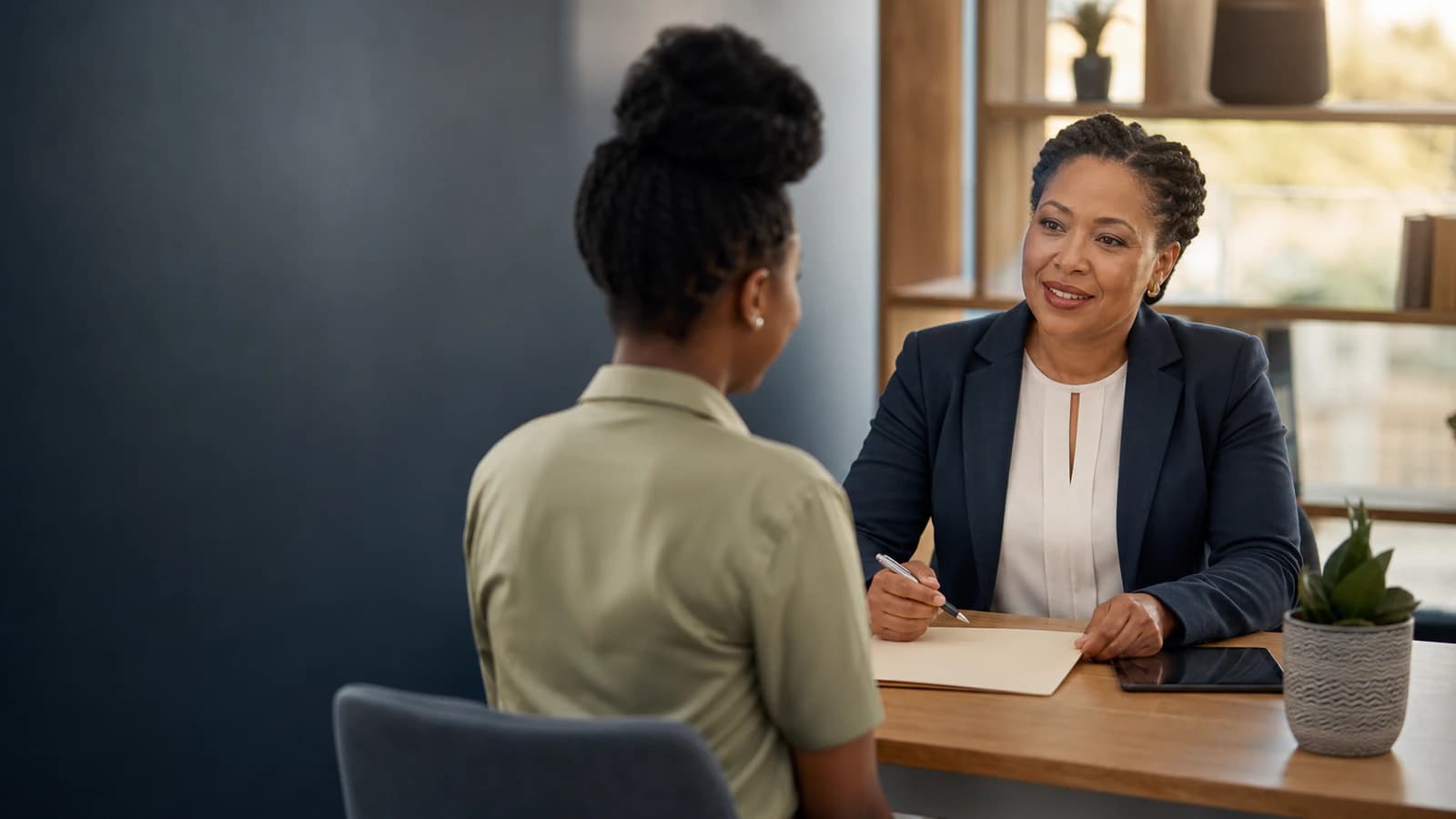An HR professional welcomes a new employee during an onboarding conversation.